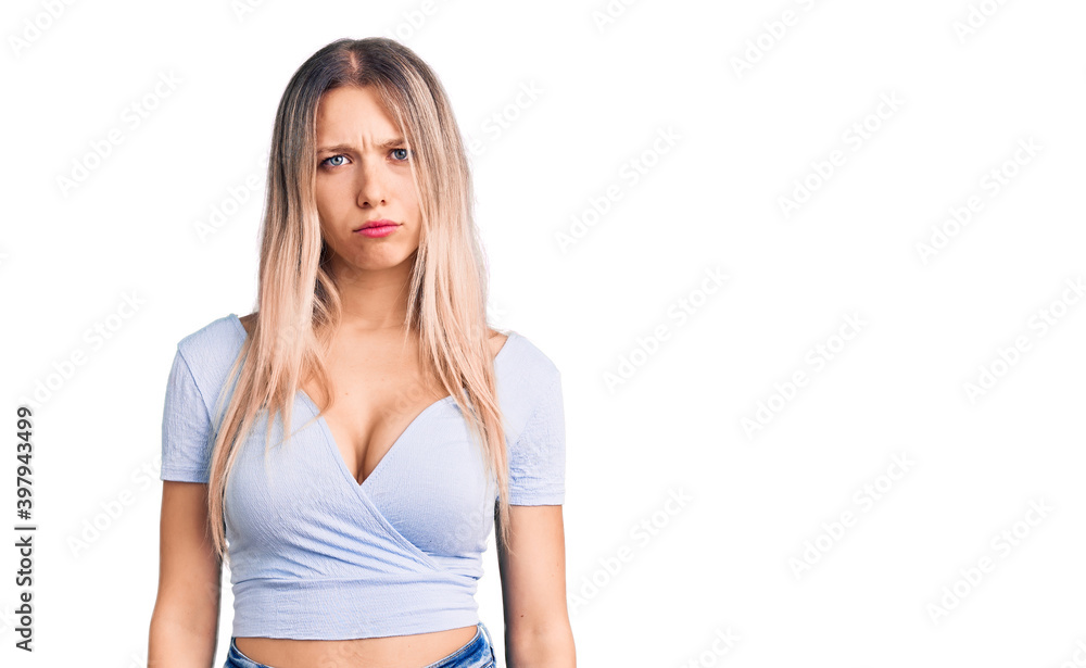Young beautiful blonde woman wearing casual clothes skeptic and nervous, frowning upset because of problem. negative person. Young beautiful blonde woman wearing casual clothes skeptic and nervous, frowning upset because of problem. negative person.