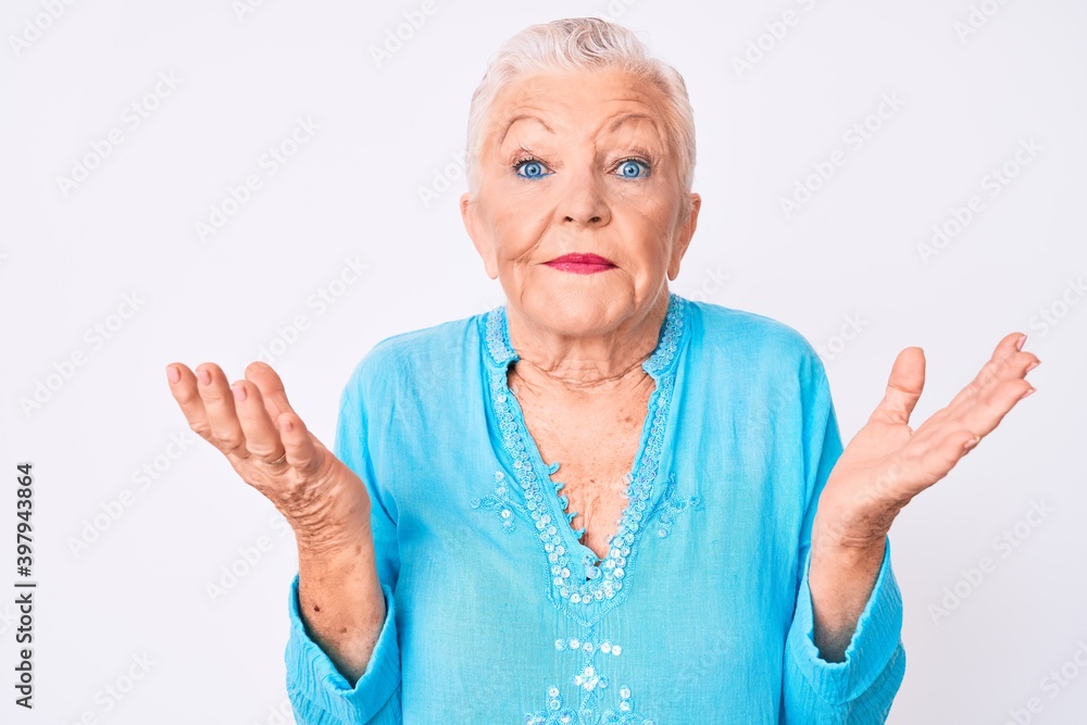 Senior beautiful woman with blue eyes and grey hair wearing summer clothes clueless and confused with open arms, no idea and doubtful face. Senior beautiful woman with blue eyes and grey hair wearing summer clothes clueless and confused with open arms, no idea and doubtful face.
