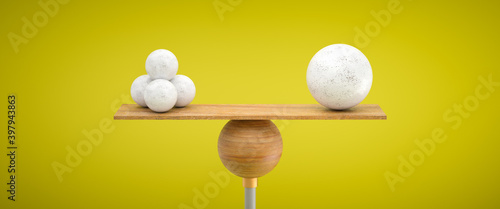 фотографія wooden scale balancing one big ball and four small ones on colorful background
