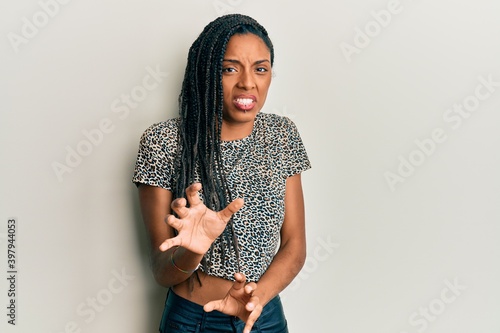 African american woman wearing casual clothes disgusted expression, displeased and fearful doing disgust face because aversion reaction. with hands raised