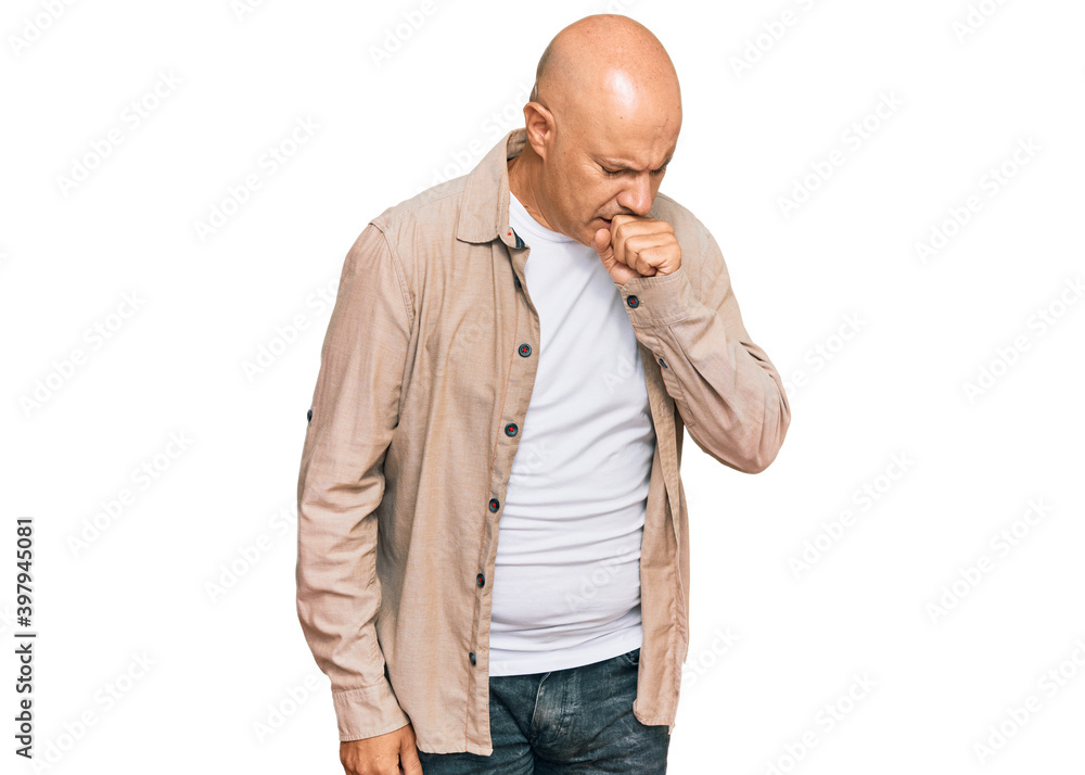 Middle age bald man wearing casual clothes feeling unwell and coughing as symptom for cold or bronchitis. health care concept. Middle age bald man wearing casual clothes feeling unwell and coughing as symptom for cold or bronchitis. health care concept.