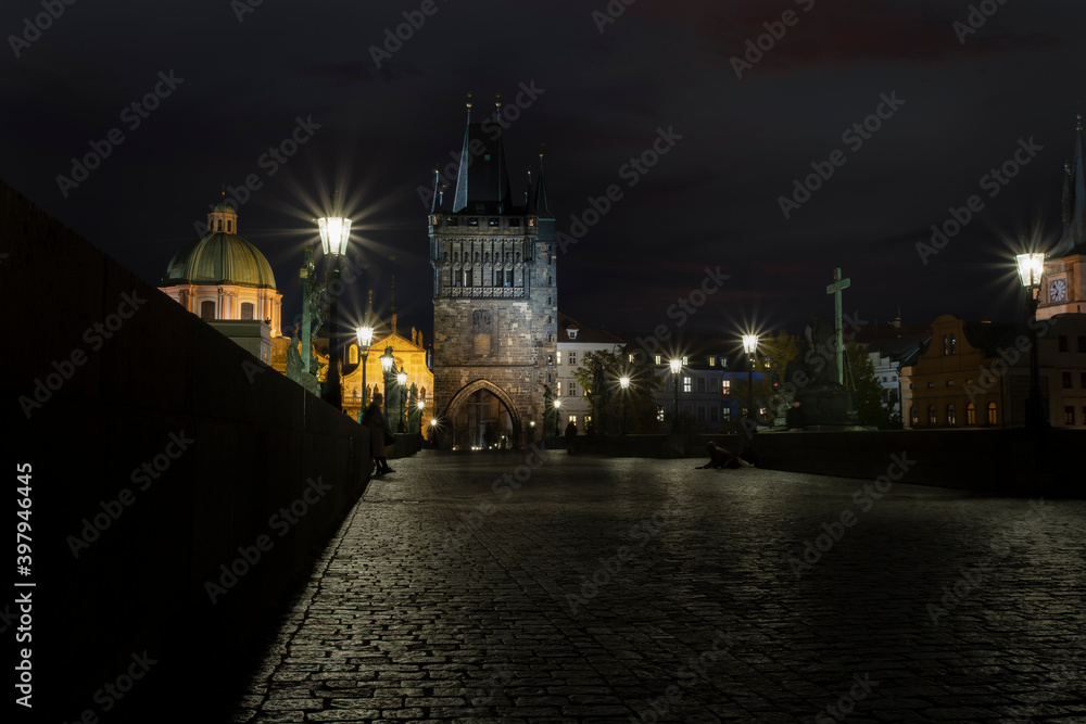 Charles Bridge and light from street lighting and stone sculptures on the bridge