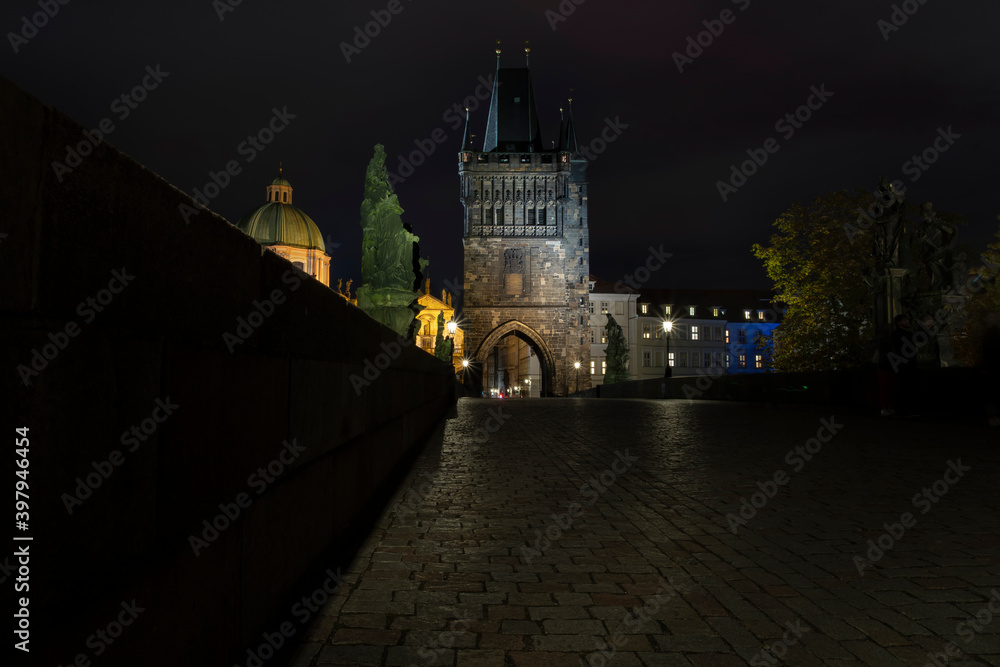Charles Bridge and light from street lighting and stone sculptures on the bridge