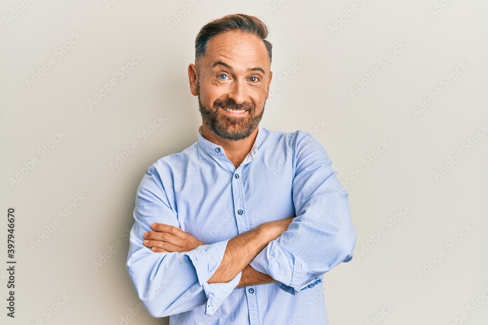 Handsome middle age man wearing business clothes happy face smiling with crossed arms looking at the camera. positive person. Handsome middle age man wearing business clothes happy face smiling with crossed arms looking at the camera. positive person.