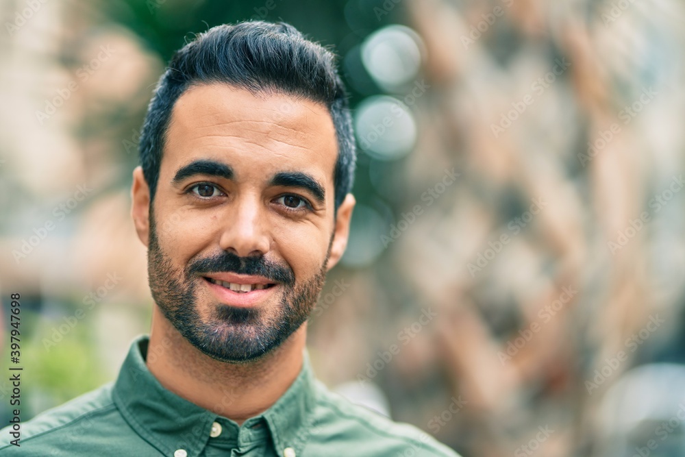Young hispanic man smiling happy standing at the city. Young hispanic man smiling happy standing at the city.