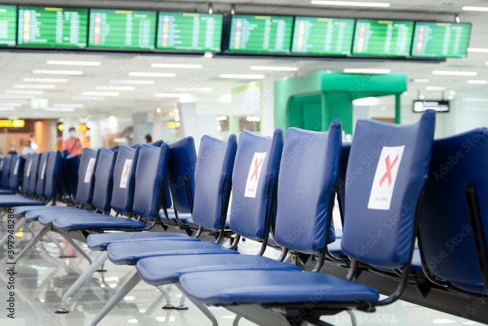 Fototapeta premium Empty row of benches in airport waiting area with 