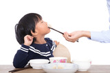 Mother is feeding children dumplings on the table in front of white background