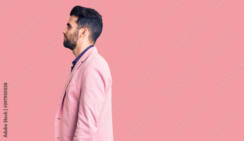 Young handsome man with beard wearing elegant jacket looking to side, relax profile pose with natural face with confident smile. Young handsome man with beard wearing elegant jacket looking to side, relax profile pose with natural face with confident smile.