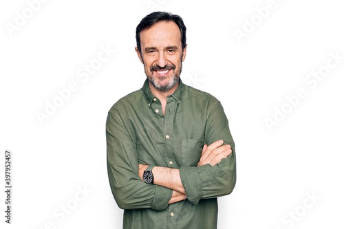 Canvas Print Middle age handsome man wearing casual green shirt over isolated white background happy face smiling with crossed arms looking at the camera