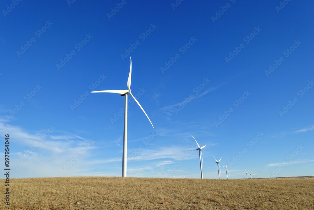 A closeup isolated vertical photo of Wind turbines in Alberta, Canada. Renewable energy concept. A closeup isolated vertical photo of Wind turbines in Alberta, Canada. Renewable energy concept.