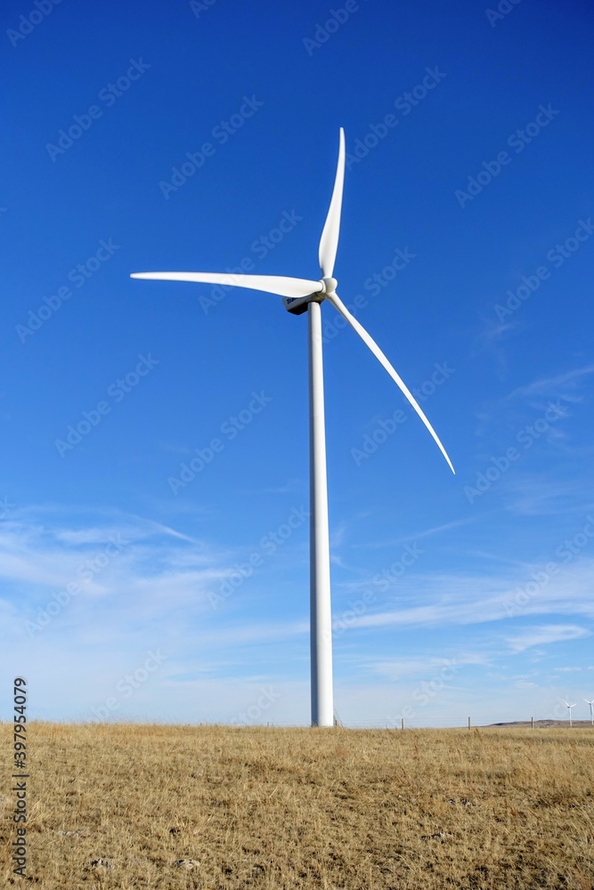 A closeup isolated vertical photo of Wind turbines in Alberta, Canada. Renewable energy concept. A closeup isolated vertical photo of Wind turbines in Alberta, Canada. Renewable energy concept.