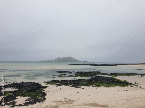 Basalt and islands in the misty Jeju Island sea