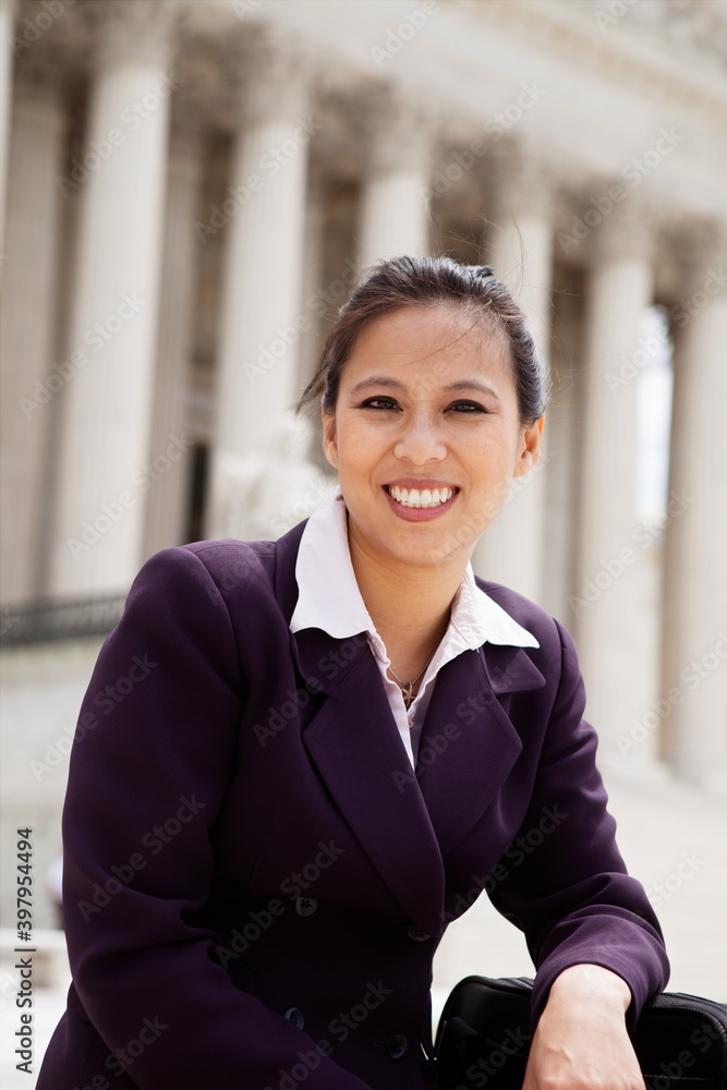 Beautiful mid adult Asian American woman in front of the U.S. Supreme Court building in Washington, DC Beautiful mid adult Asian American woman in front of the U.S. Supreme Court building in Washington, DC