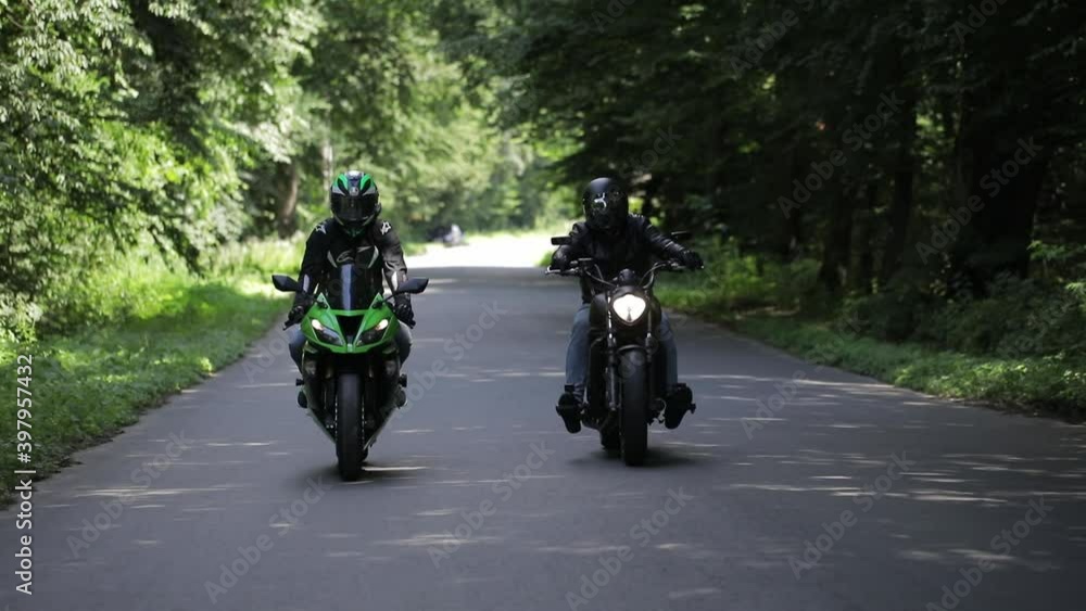 motorcyclist biker rides a motorcycle. Rides on a country road Adventures on a cat bike in nature. motorcyclist biker rides a motorcycle. Rides on a country road Adventures on a cat bike in nature.