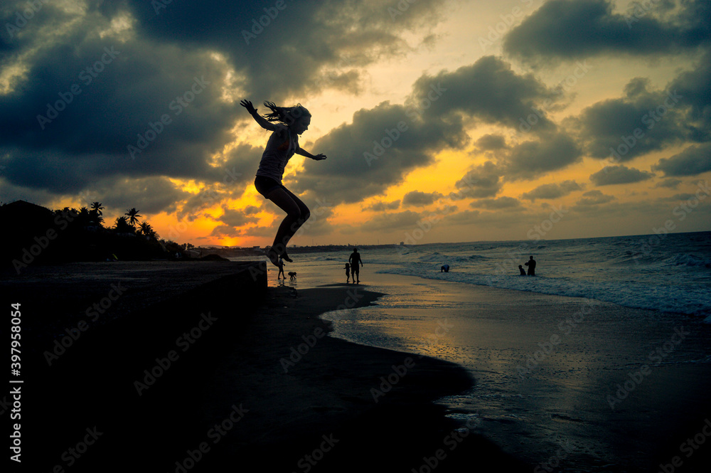 silhouette of person jumping on beach