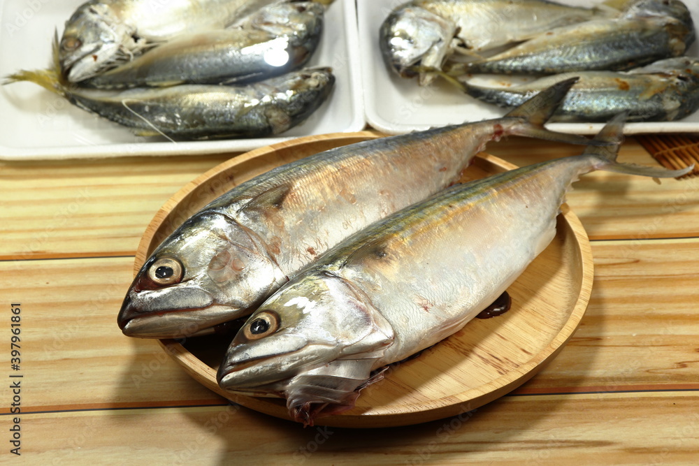 Selective focus, Pile of fresh Mackerel fish on the wooden plate. Famous seafood ingredients in Asia restaurant. Preparation food concept. Selective focus, Pile of fresh Mackerel fish on the wooden plate. Famous seafood ingredients in Asia restaurant. Preparation food concept.