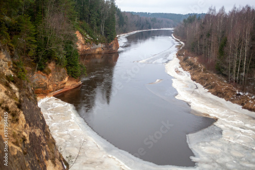 Latvian nature  with a beautiful river and tree branches  with a green landscape