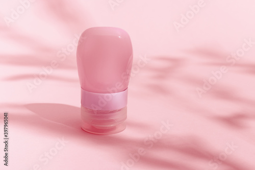 Cosmetic Bottle for cream, gel, lotion. Beauty product package, mock up plastic container with dark light, pink toned