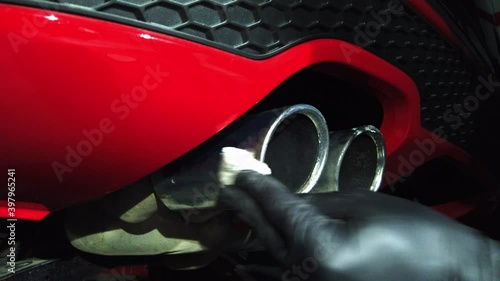Manual car wash. A man washes his sedan from a special hose. Manual portable car wash. Detailed and gentle car care