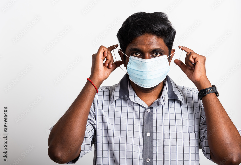 Asian happy portrait young black man wearing face mask protective from virus coronavirus epidemic or air pollution looking camera, studio shot isolated on white background, stop COVID-19 concept Asian happy portrait young black man wearing face mask protective from virus coronavirus epidemic or air pollution looking camera, studio shot isolated on white background, stop COVID-19 concept