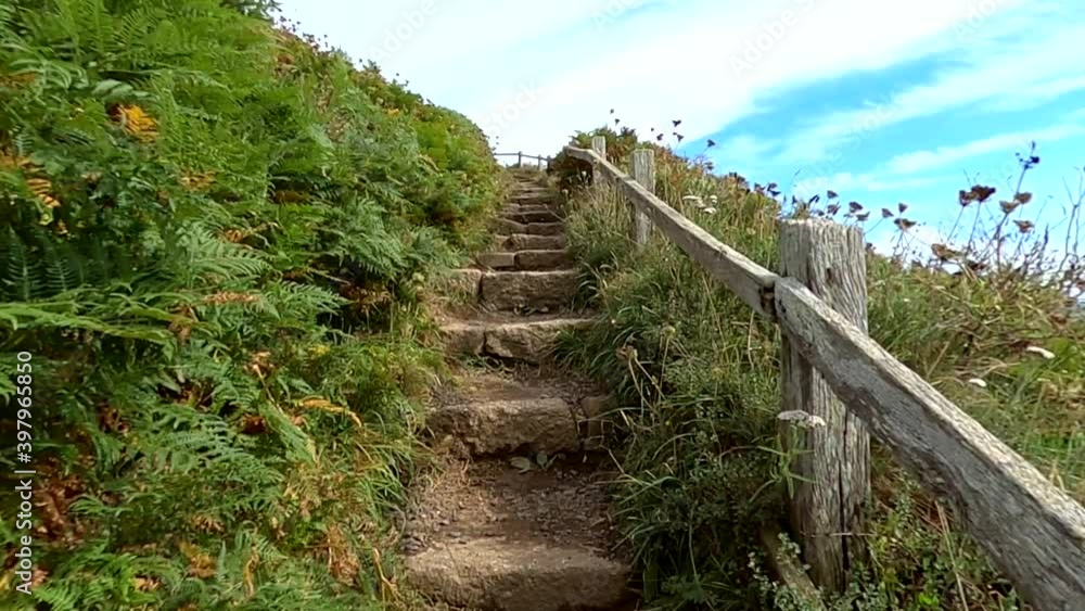 Climbing up scenic stairs along a coastal path Climbing up scenic stairs along a coastal path