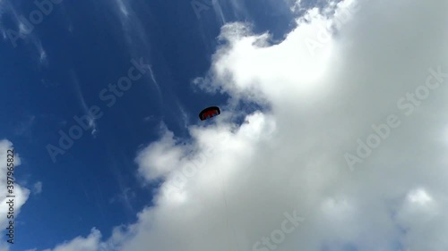 Power kite flying high in the sky with a blue summer sky in the back ground photo