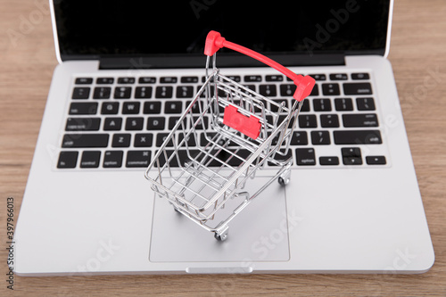 An empty shopping cart model on a laptop keyboard