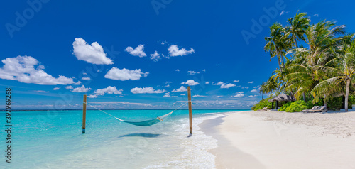 Fototapeta Naklejka Na Ścianę i Meble -  Tropical beach paradise as summer landscape with beach swing or hammock and white sand, calm sea for serene beach. Luxury beach scene vacation summer holiday. Exotic island nature travel destination