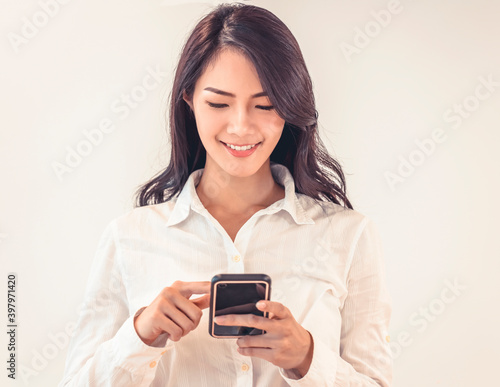 Portrait of happy businesswoman using mobile phone