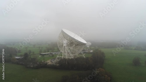 Aerial Jodrell bank observatory Lovell telescope misty rural countryside push in wide orbit right photo