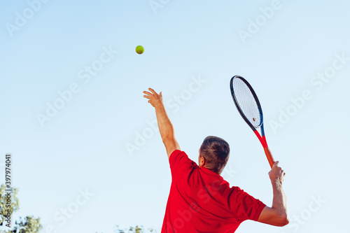 Young proffesional tennis player doing a serve © fotofabrika