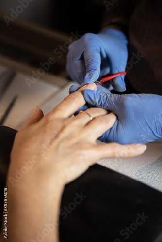 Closeup shot of a woman in a nail salon receiving a manicure