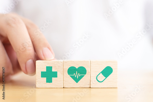Hand arranging wood block with icon healthcare medical, Insurance for your health concept photo