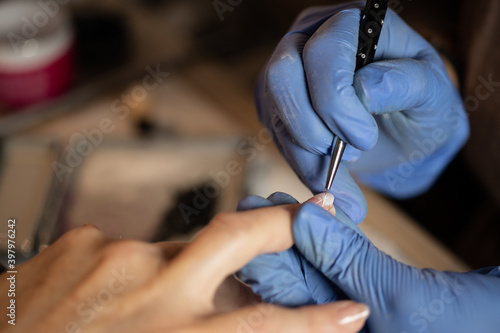 Closeup shot of a woman in a nail salon receiving a manicure