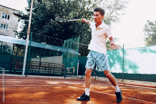 Fit man plays tennis on tennis field © fotofabrika
