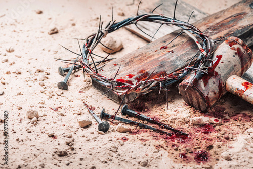 Принти на полотні Old wooden cross, hammer, bloody nails and crown of thorns on ground