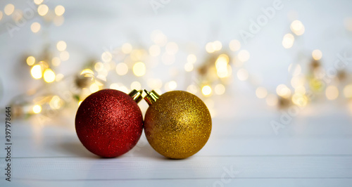 Christmas balls and garlands on a blue and white background with beautiful lights and bokeh. Christmas New Year background. Merry christmas concept  greeting card  banner