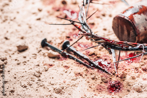 Old wooden cross, hammer, bloody nails and crown of thorns on ground. Banner. Copy space. Good friday. Passion, crucifixion of Jesus Christ. Christian Easter holiday. Gospel, salvation photo