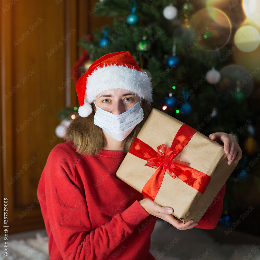 girl in red clothes and medical mask unfold New year gifts. the concept of celebrating Christmas midnight. Holiday's decor boce, Christmas tree girl in red clothes and medical mask unfold New year gifts. the concept of celebrating Christmas midnight. Holiday's decor boce, Christmas tree
