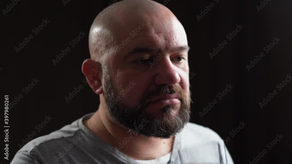 a Caucasian man of appearance lays down a pill on his tongue and drinks it with a glass of water. Illness treatment concept a Caucasian man of appearance lays down a pill on his tongue and drinks it with a glass of water. Illness treatment concept