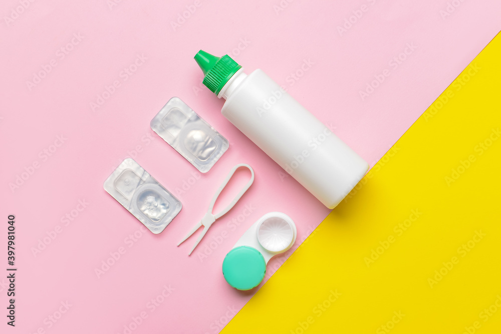 Container with contact lenses, solution and tweezers on color background Container with contact lenses, solution and tweezers on color background