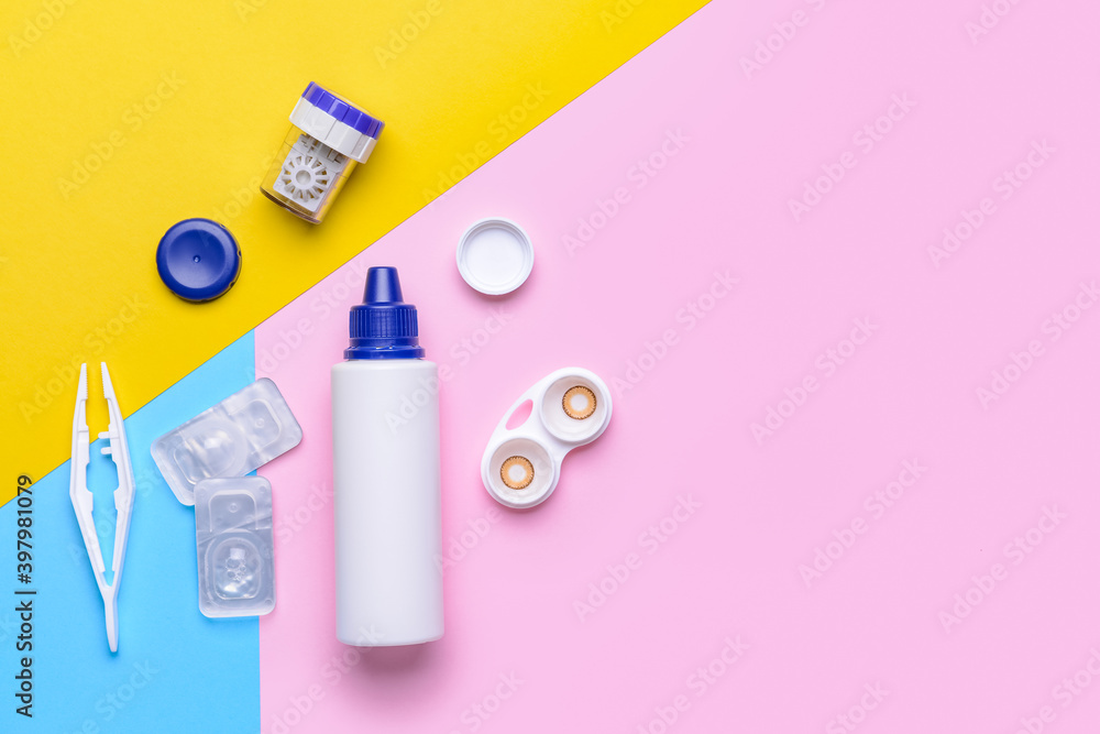 Containers with contact lenses, solution and tweezers on color background Containers with contact lenses, solution and tweezers on color background