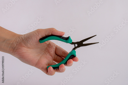 Hand holding pliers isolated on white background.