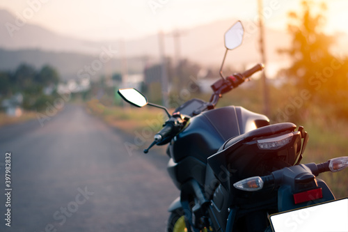 Motorcycle parking on the road, Vintage style with sunset light, copy spec for individual text, motorbike wit nature landscape
