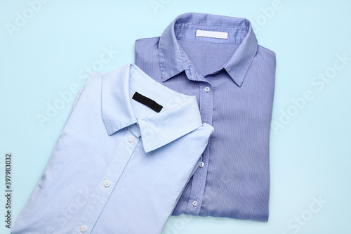 Stylish male shirts on color background