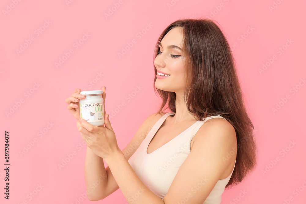 Beautiful young woman with coconut oil on color background Beautiful young woman with coconut oil on color background