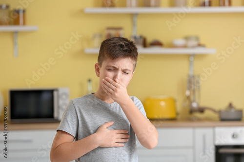 Coughing little boy at home