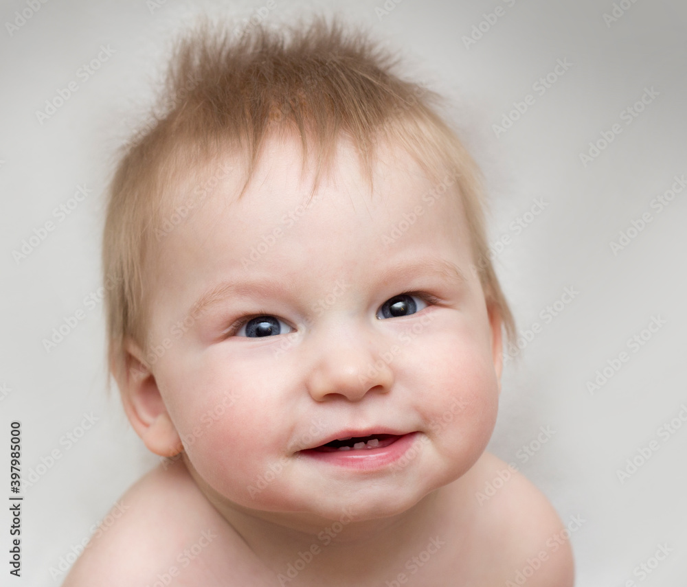 Portrait of a cute smiling baby that showing first milk or temporary teeth