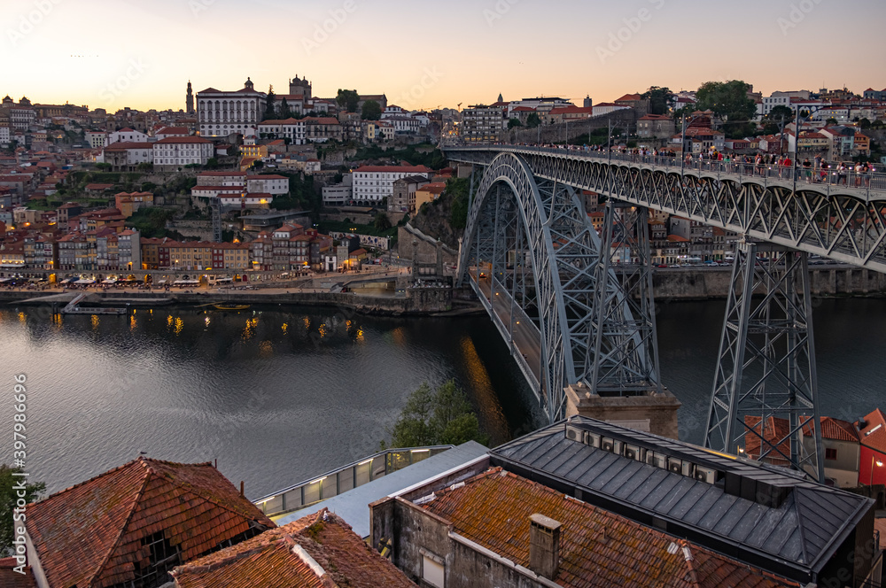 Tram and pedestrians cross the Ponte Luis in Porto