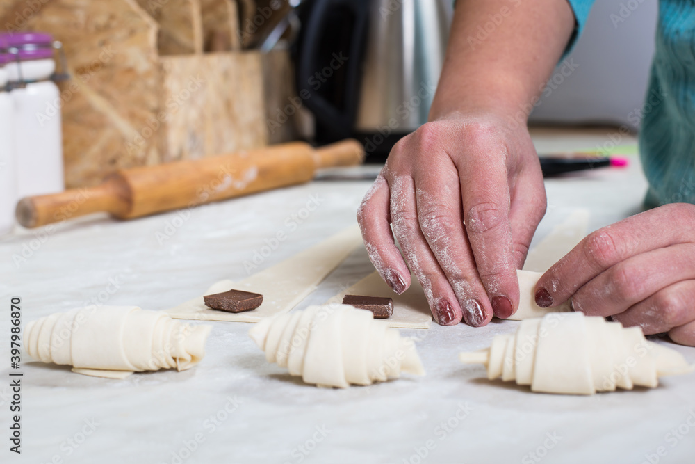 Working with puff pastry. Home baking. Raw croissant. Working with puff pastry. Home baking. Raw croissant.